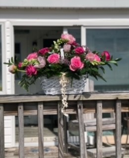 White basket with pink flowers.