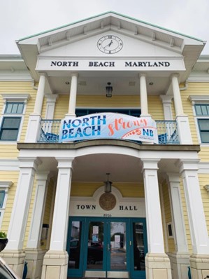 Town Hall in North Beach with North Beach Strong banner hanging on the balcony.