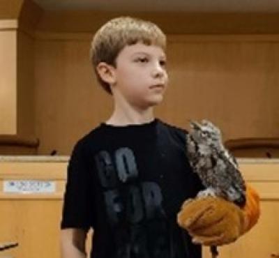 boy holding owl