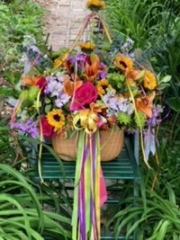 Multi color flowers in a hanging basket.